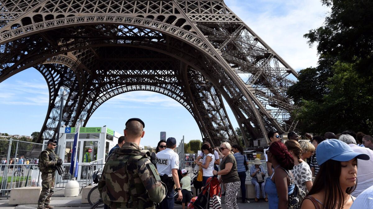 Police officers patrol around the Eiffel Tower in Paris on Sept. 10.