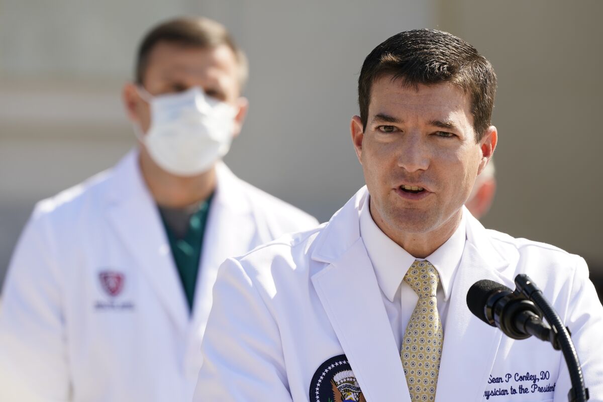 Dr. Sean Conley, White House physician, briefs reporters at Walter Reed hospital in Bethesda, Md., on Sunday.