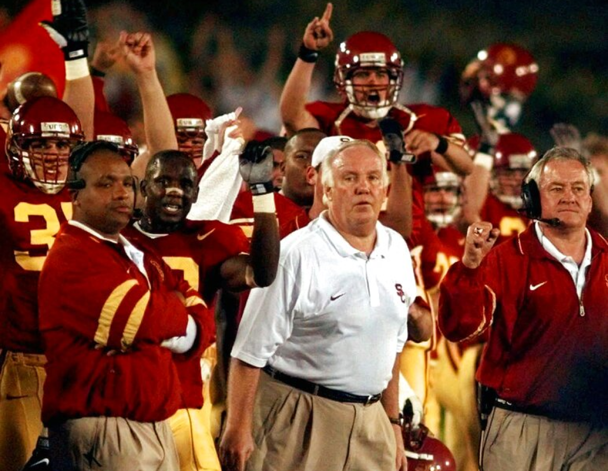 USC coach John Robinson, center, looks on as the Trojans score a touchdown against UNLV on Oct. 4, 1997.