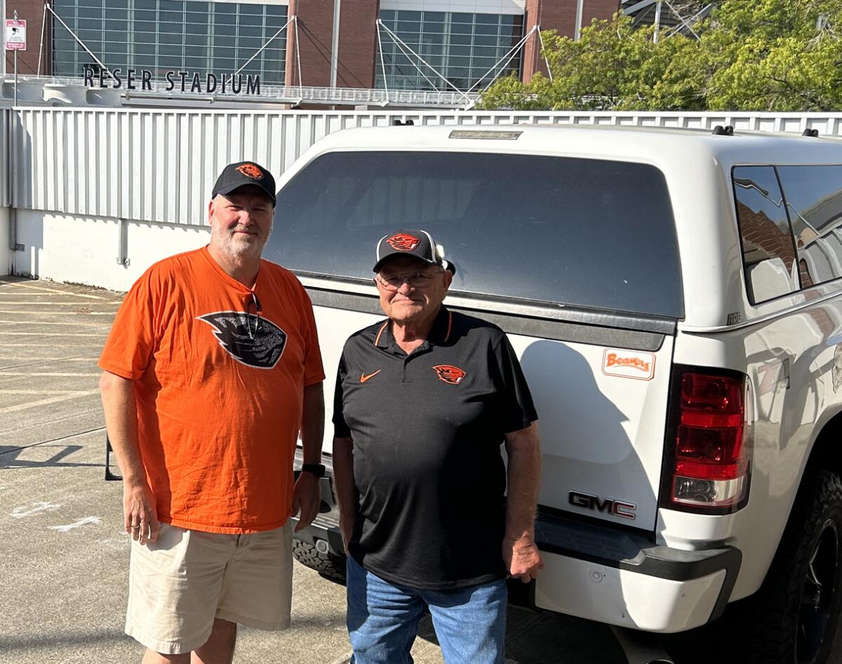 Oregon State fans Ted Kintz (left) and Don Wolf prepare to enjoy pregame festivities Saturday morning outside Reser Stadium.
