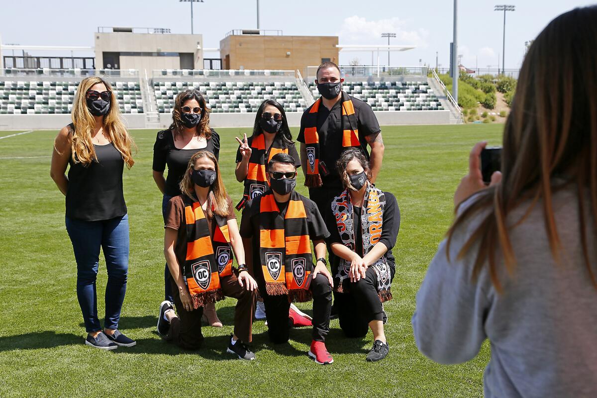 Hoag Hospital healthcare workers take a group picture at Championship Soccer Stadium in Irvine on Saturday.