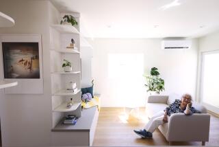 WESTWOOD, CA - SEPTEMBER 10, 2024 - Isabel Janken, 96, sits in the living room of her new ADU in Westwood on September 10, 2024. Janken used to live in the duplex and now lives in an assisted living facility. The ADU is in the rear of an existing rented duplex where architect Melissa Shin demolished the garage, then built the new ADU atop a new 3-car garage and a private rooftop with panoramic views. The ADU has one bedroom, a full kitchen, a living room with a built-in entertainment center, a large bedroom with room for a desk and a rooftop terrace. (Genaro Molina/Los Angeles Times)