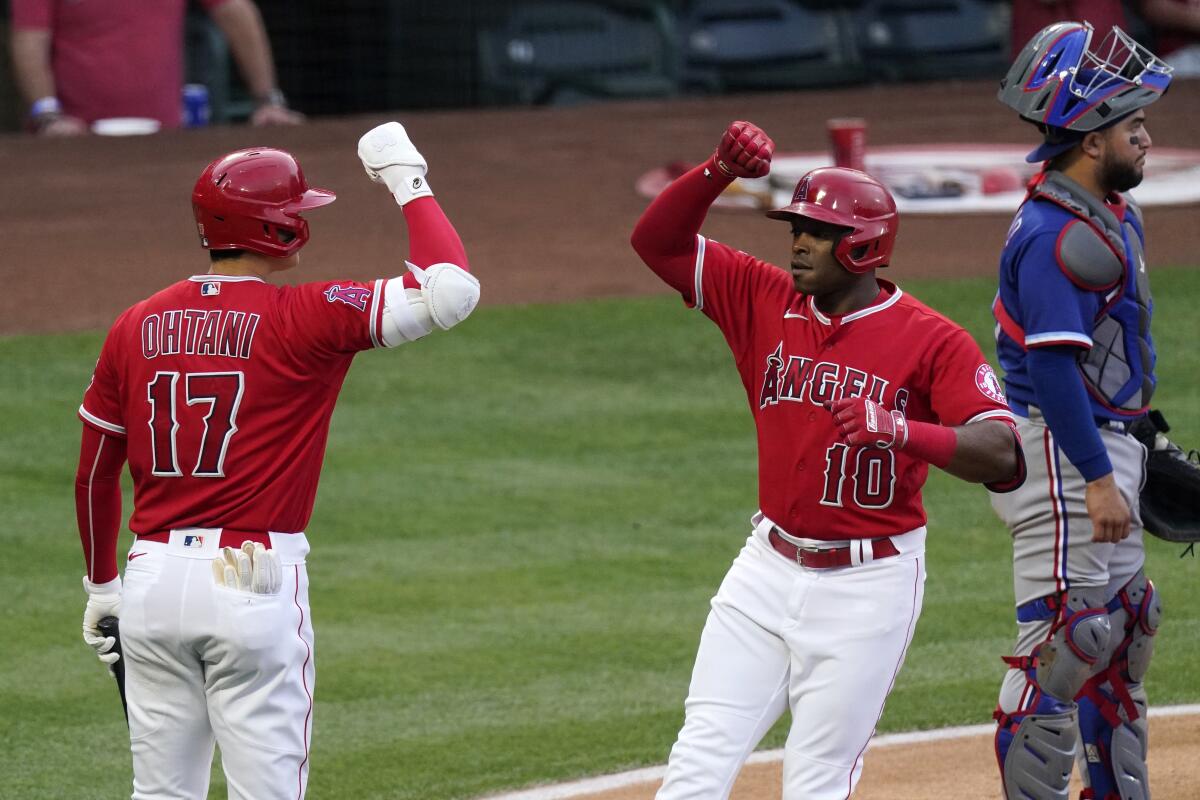 Angels' Justin Upton is congratulated by Shohei Ohtani after hitting a solo home run.