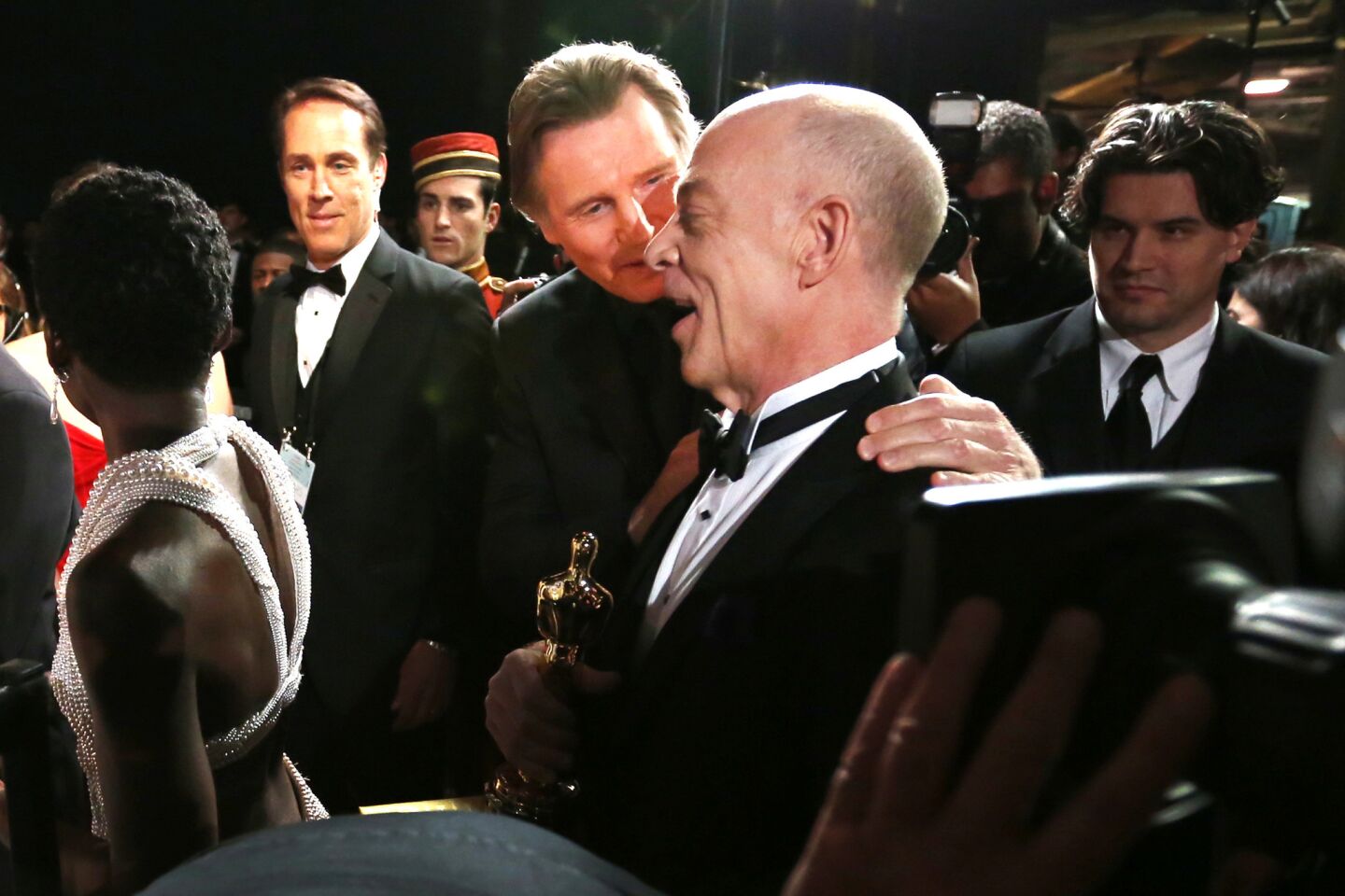 Actors Liam Neeson and J.K. Simmons, right, chat backstage at the 87th Academy Awards after Simmons won a supporting actor prize for "Whiplash" in 2015.