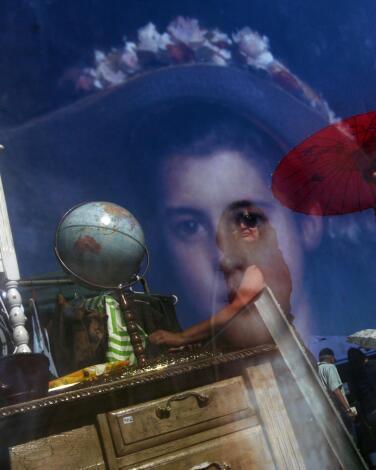 People shop for antiques at an outdoor flea market 