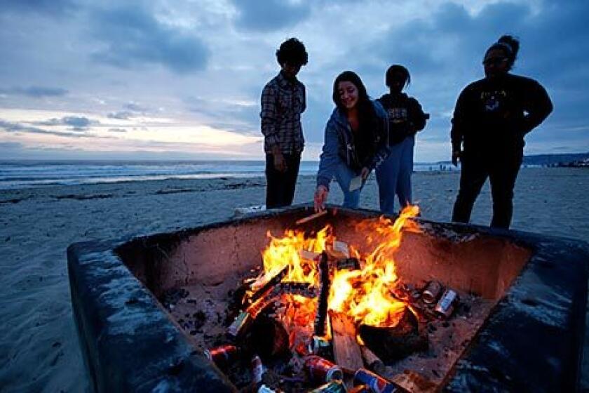 San Diego residents Eliseo Rivas, 18, left, Alyx Balter, 18, Sewit Berhane, 18, and Alexis Najera, 17, celebrate Berhane's birthday at Mission Beach.