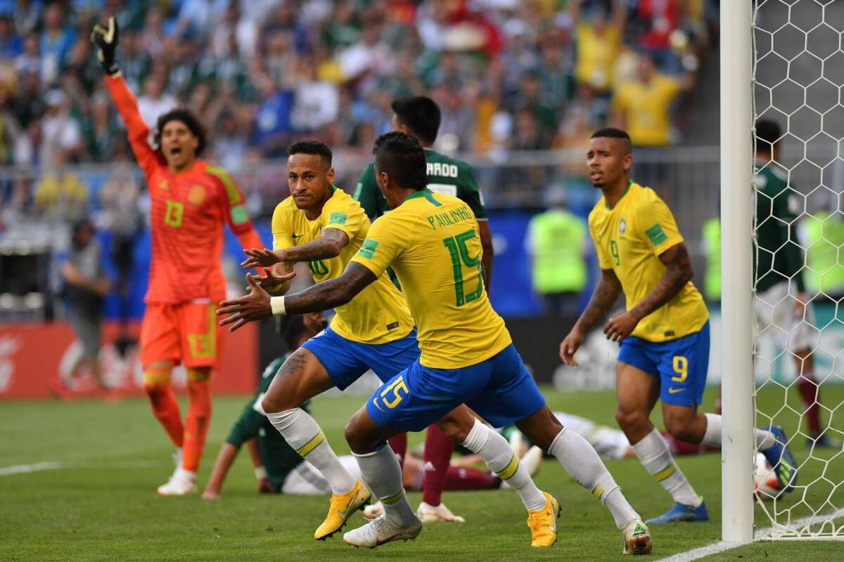 Brazil's forward Neymar (2L) celebrates after scoring the opening goal during the Russia 2018 World Cup round of 16 football match between Brazil and Mexico at the Samara Arena in Samara on July 2, 2018.