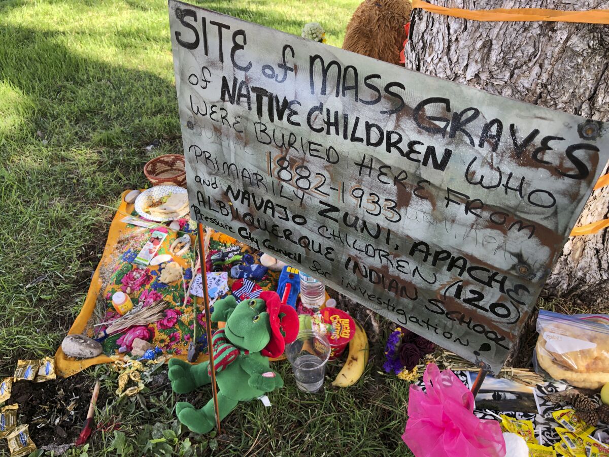 FILE - A makeshift memorial for the dozens of Indigenous children who died more than a century ago while attending a boarding school that was once located nearby is displayed under a tree at a public park in Albuquerque, N.M., on July 1, 2021. The U.S. Interior Department is expected to release a report Wednesday, May 11, 2022, that it says will begin to uncover the truth about the federal government's past oversight of Native American boarding schools. (AP Photo/Susan Montoya Bryan, File)
