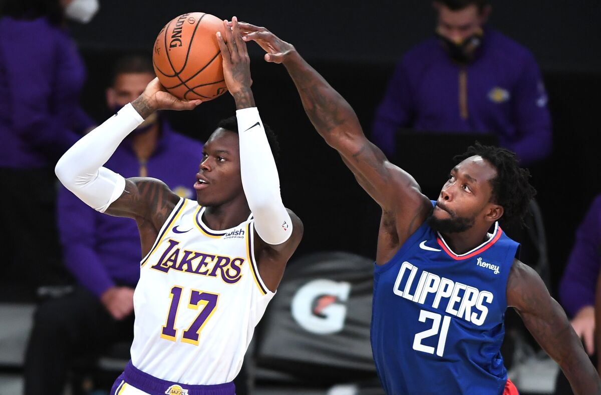 Clippers guard Patrick Beverley tries to block a shot by Lakers guard Dennis Schroder.