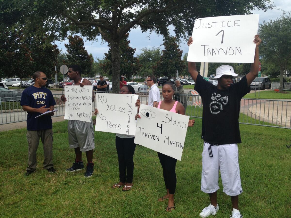 Protesters gather outside the courthouse in Sanford, Fla., as the jury in the George Zimmerman murder trial begins deliberations.
