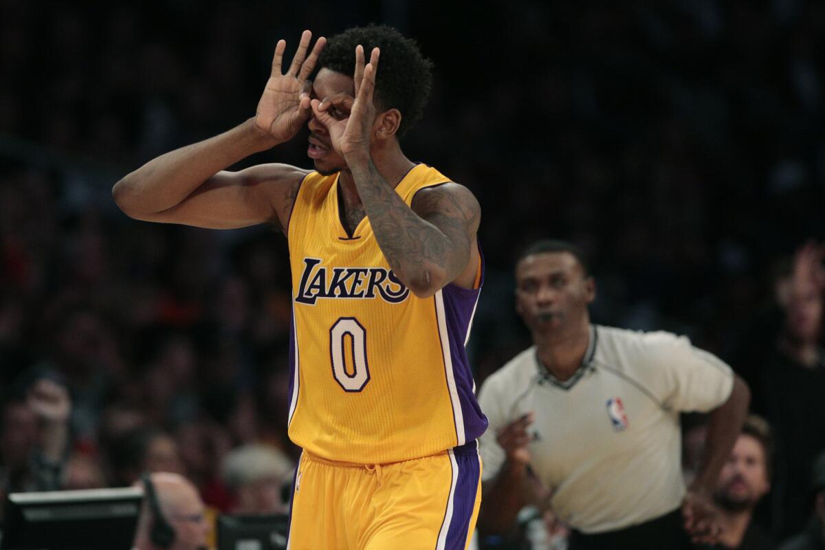 Lakers forward Nick Young celebrates after making a three-point shot against the Thunder in the third quarter. Young was later ejected for elbowing Thunder center Steven Adams.