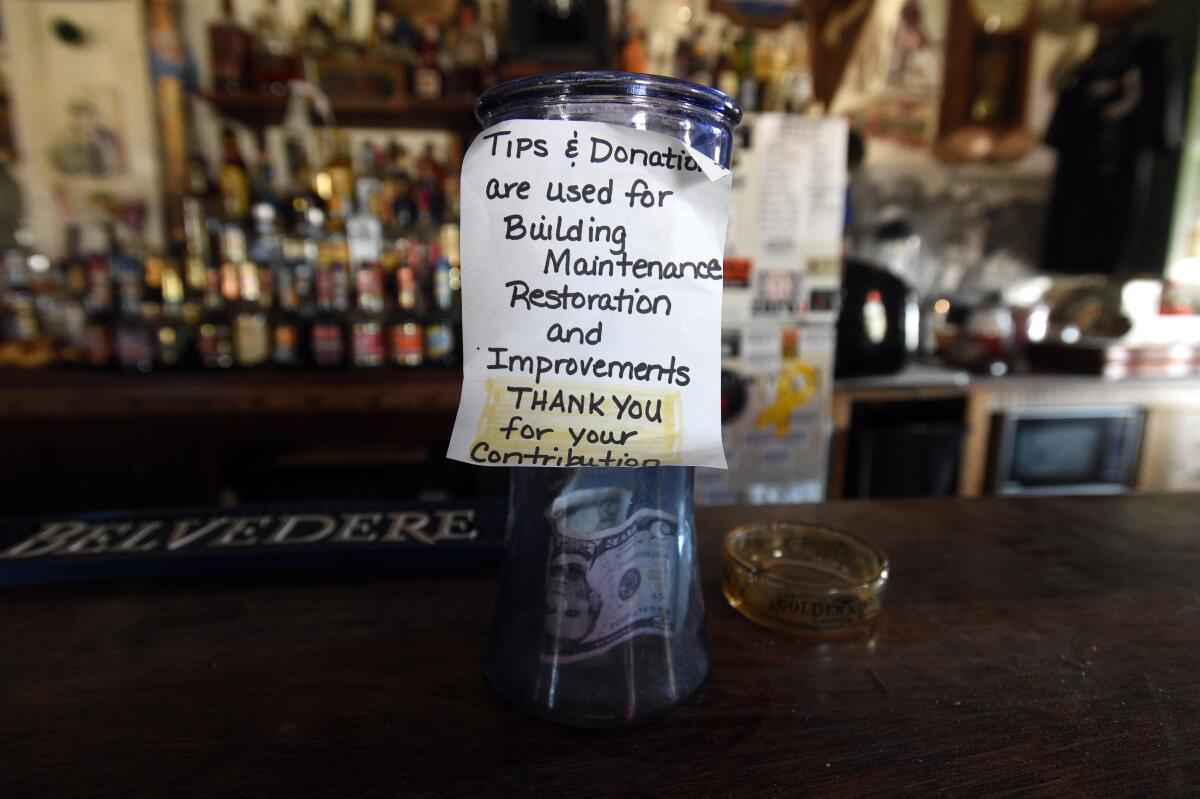 A donation cup sits on the bar top of Walt Kremin's Horn Silver Saloon in Gold Point, Nev. Without a liquor license to sell beer and other spirits, Kremin insists he only accepts donations as payment.