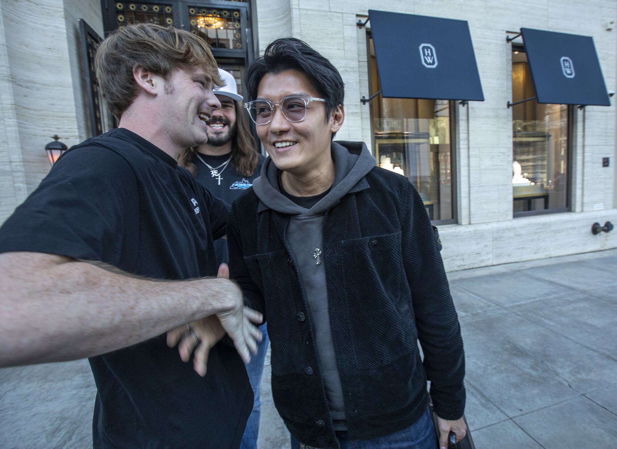 Daniel Macdonald, left, shakes hands with Stone Xie