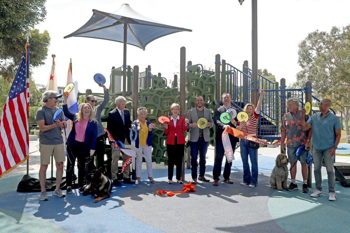 Newport Beach elected officials and parks commissioners participate in a ribbon-cutting event.