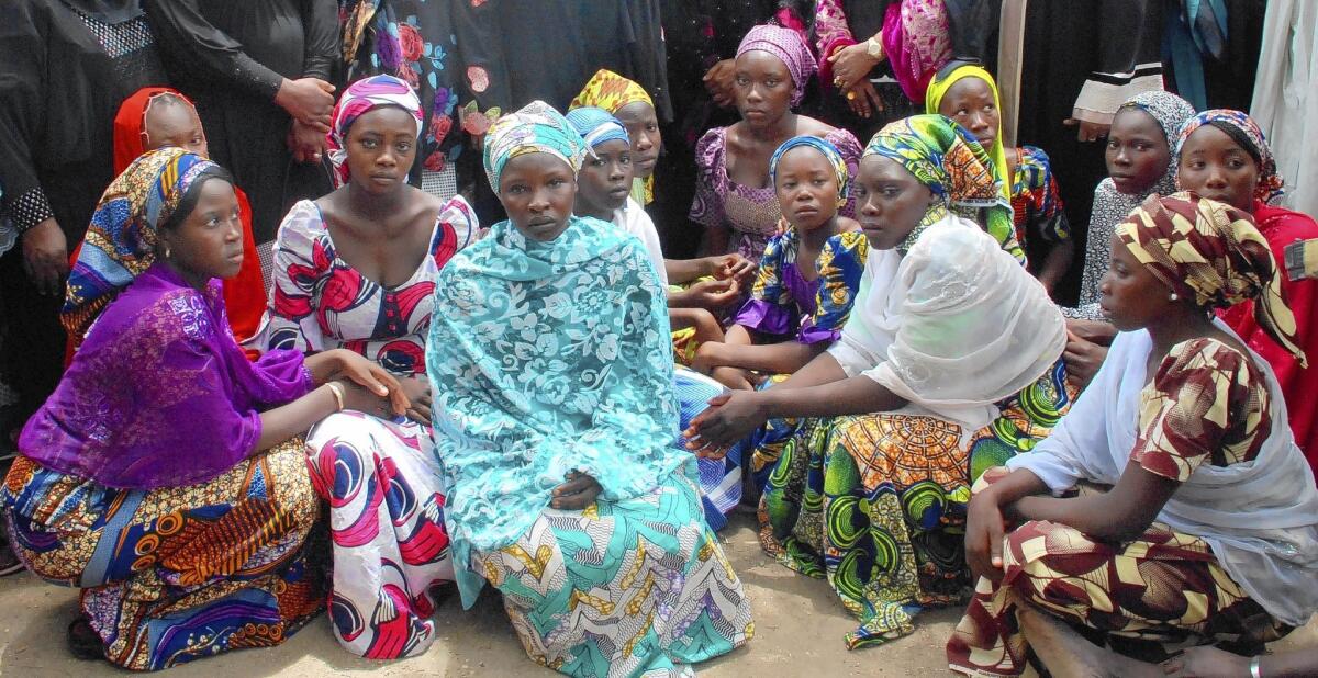 Schoolgirls who escaped from Boko Haram militants receive information from Nigerian officials.