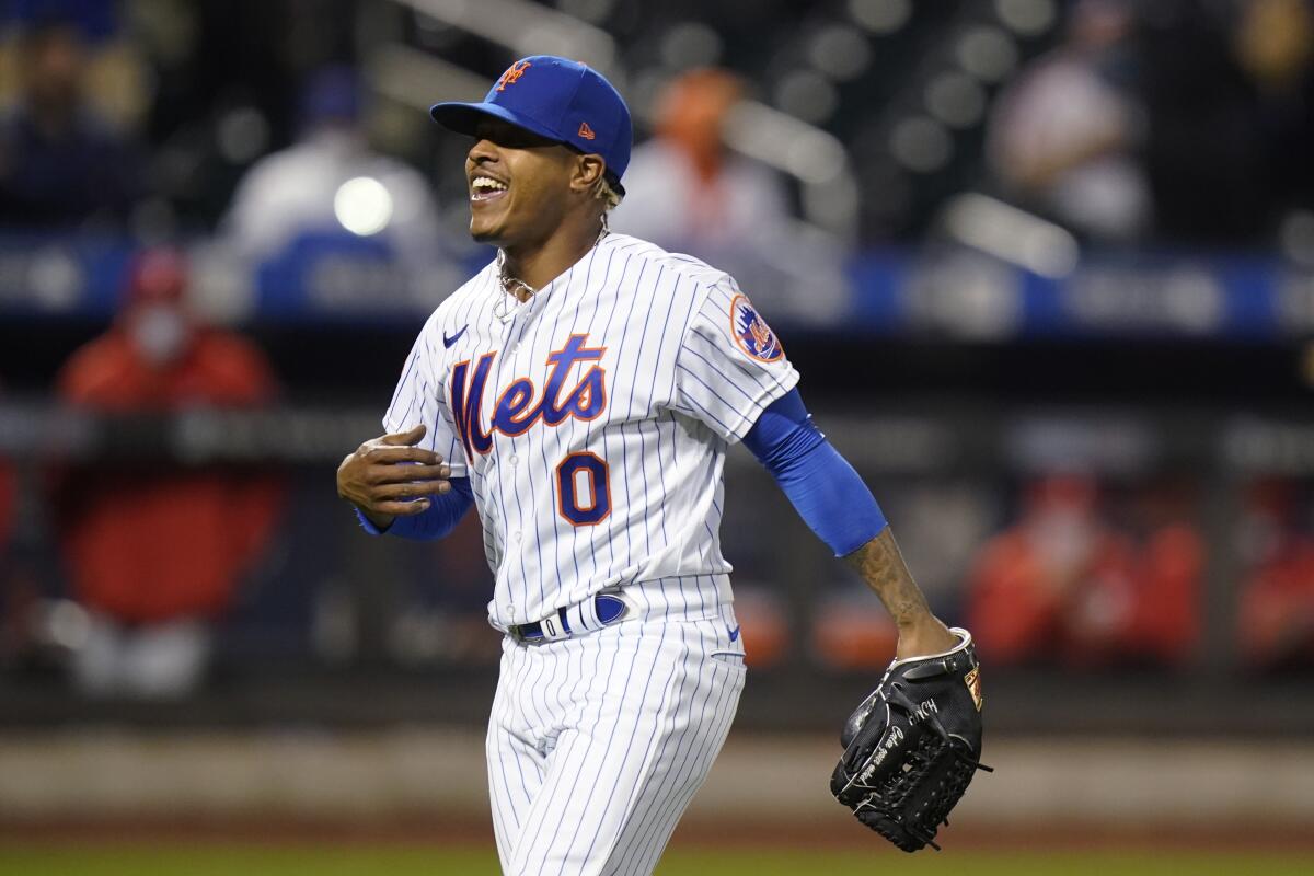 New York Mets starting pitcher Marcus Stroman celebrates after Philadelphia Phillies' Rhys Hoskins grounded into a double play during the sixth inning of the second baseball game of a doubleheader Tuesday, April 13, 2021, in New York.(AP Photo/Frank Franklin II)