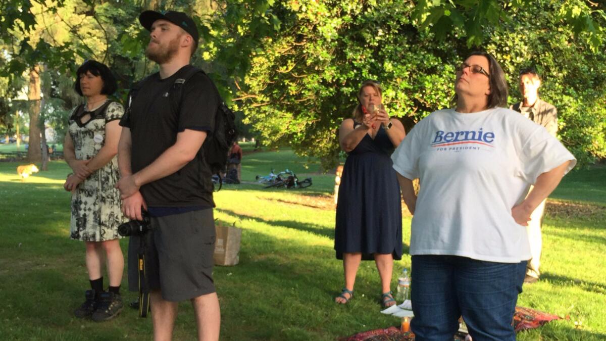 Leigha Lafleur, holding a candle, leads a Wiccan ritual to support Democratic presidential candidate Bernie Sanders on Friday in Portland.