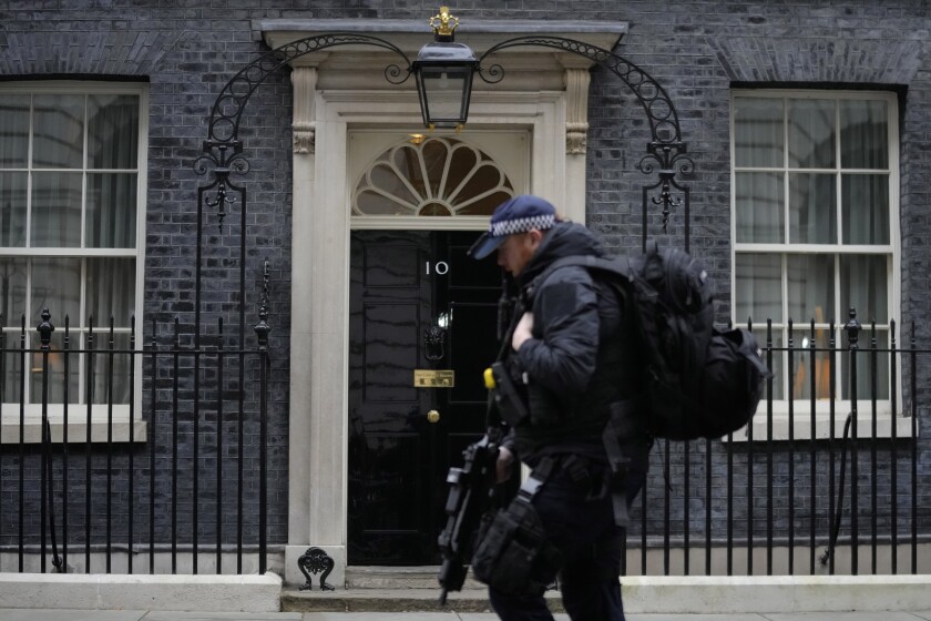 A police officer walks past 10 Downing Street in London.