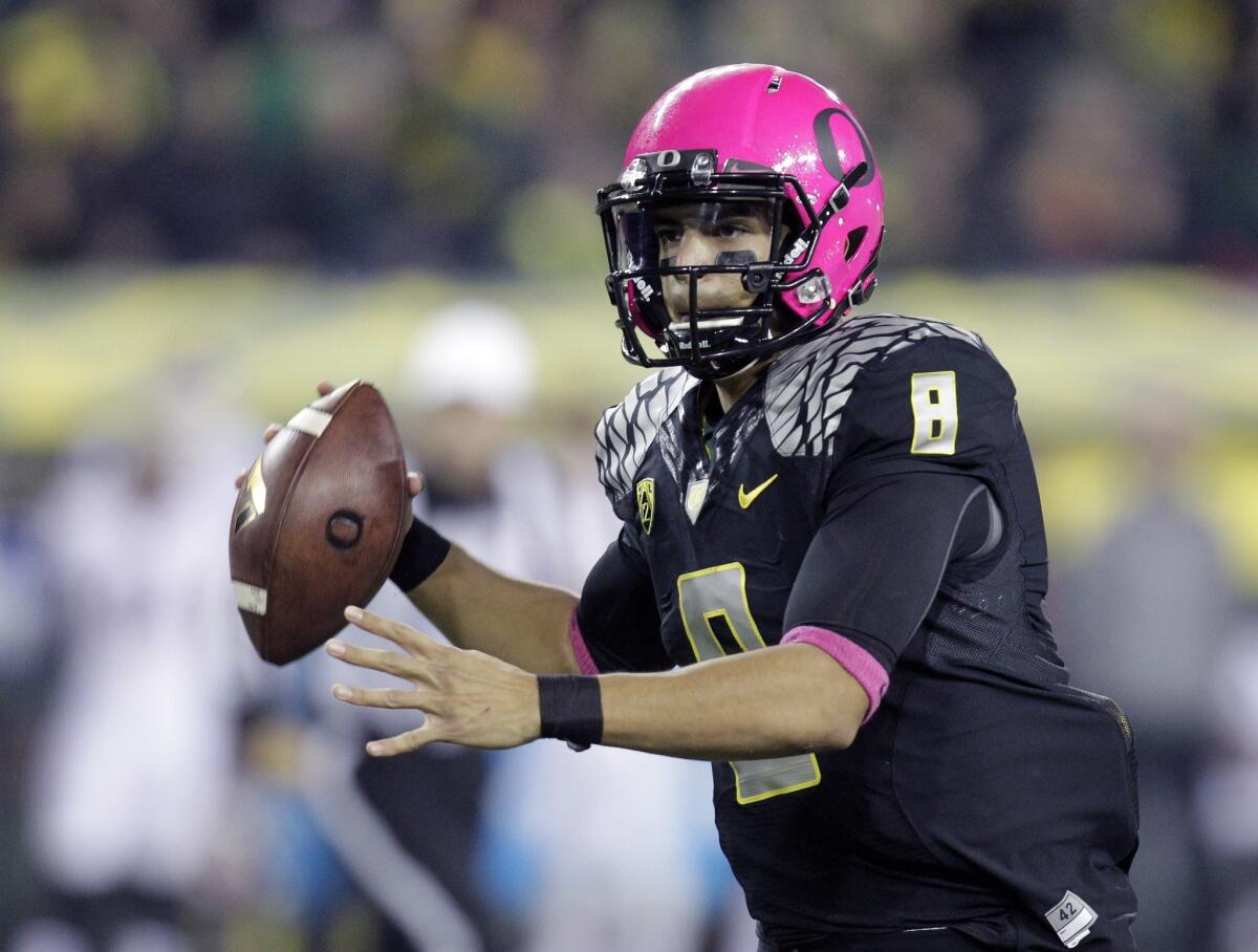 Oregon quarterback Marcus Mariota rolls out of the pocket during a game against Washington State in Eugene, Ore., on Oct. 19, 2013.