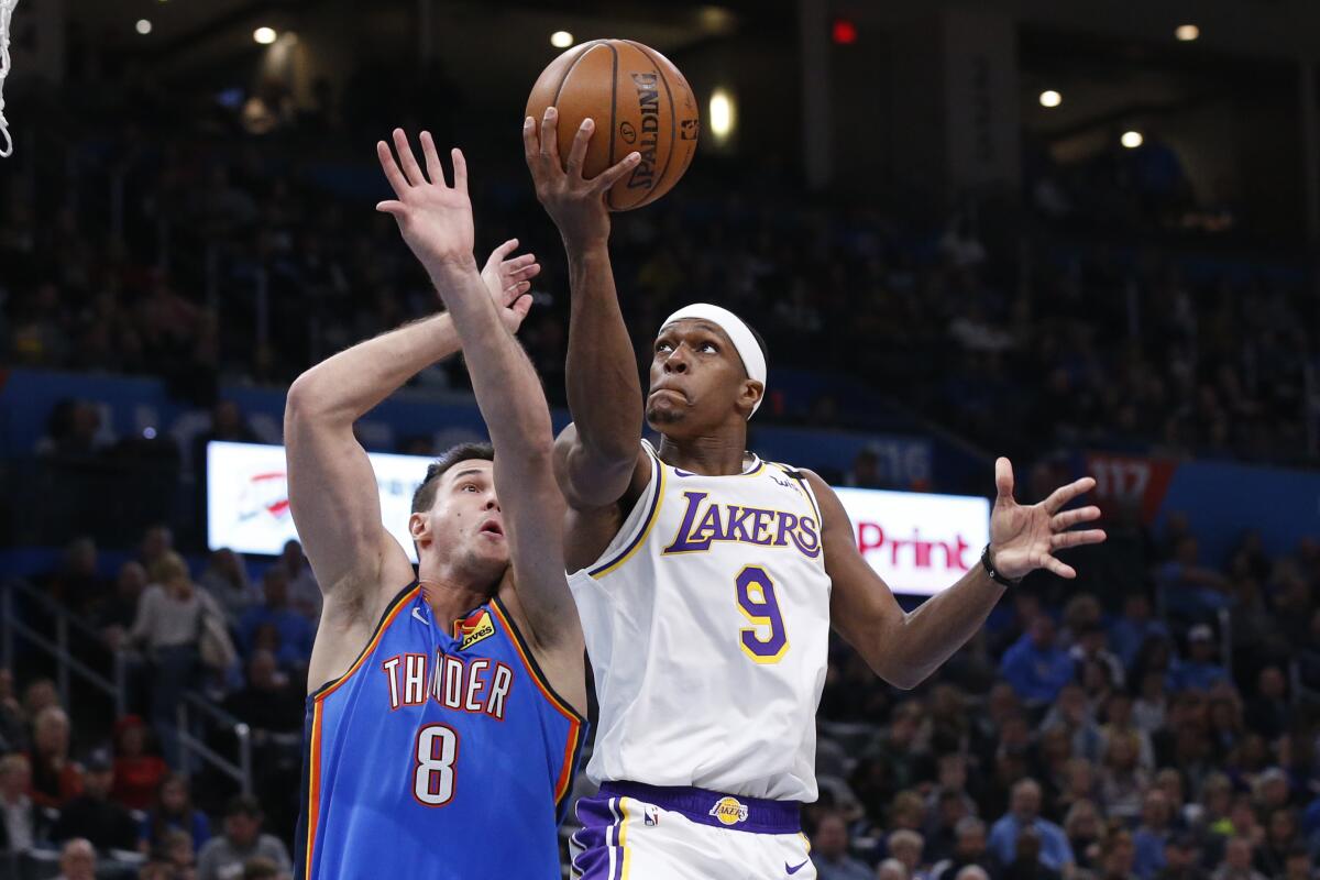 Lakers point guard Rajon Rondo attempts a layup against Thunder forward Danilo Gallinari in Oklahoma City.