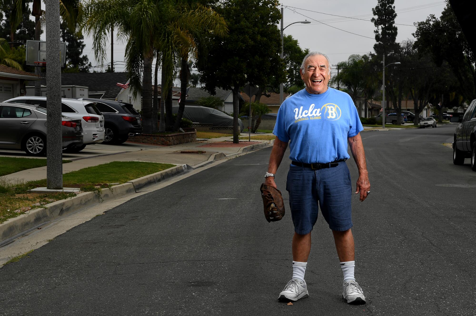 Ernie Rodriguez in his Whittier neighborhood with the first baseball glove he owned.