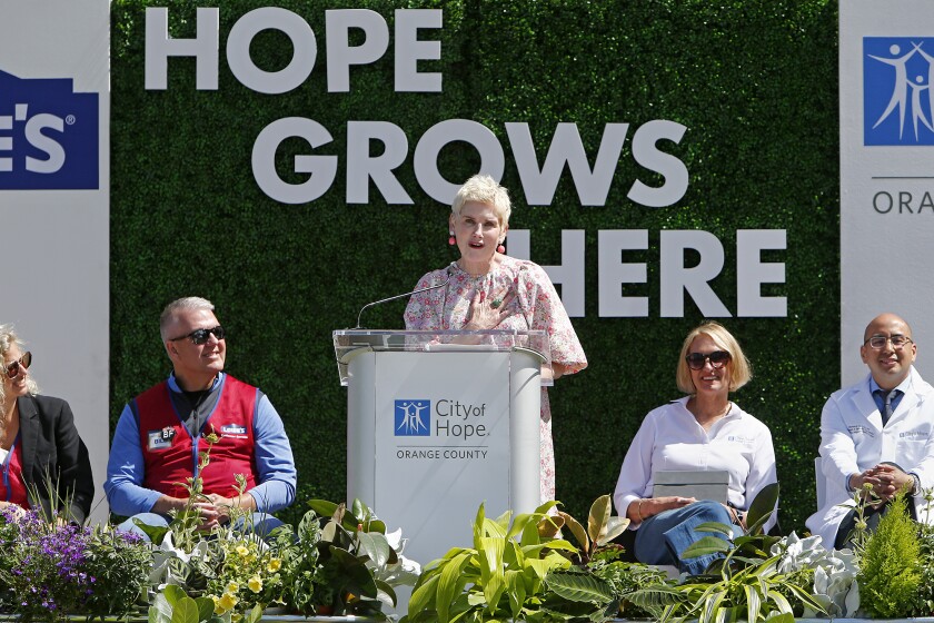 Donna McNutt, center, of Laguna Beach, speaks during an event for the new healing garden at City of Hope on Wednesday.