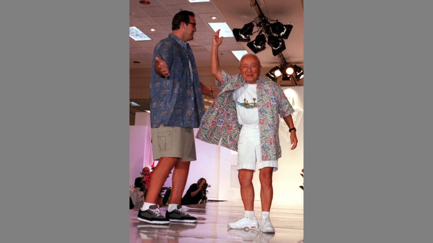 Matt Willig, left, and Sammy Lee wear Hawaiian shirts and shorts on the runway during the Gentlemen's Haberdashery 2000, a benefit for the Heart of Jesus Retreat Center, at the Newport Beach Marriott.