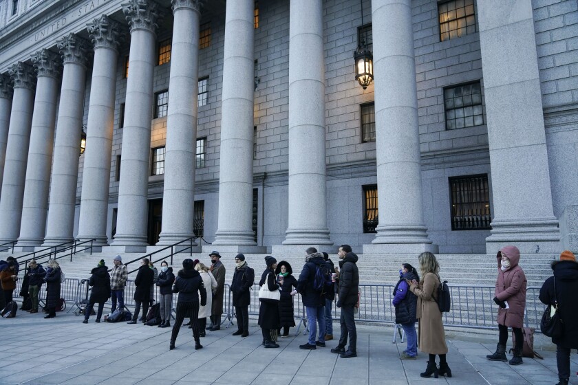 A line of people, mostly journalists, wait to enter the courthouse for the start of the Ghislaine Maxwell trial in New York, Monday, Nov. 29, 2021. Two years after Jeffrey Epstein's suicide behind bars, a jury is set to be picked Monday in New York City to determine a central question in the long-running sex trafficking case: Was his longtime companion, Ghislaine Maxwell, Epstein's puppet or accomplice? (AP Photo/Seth Wenig)