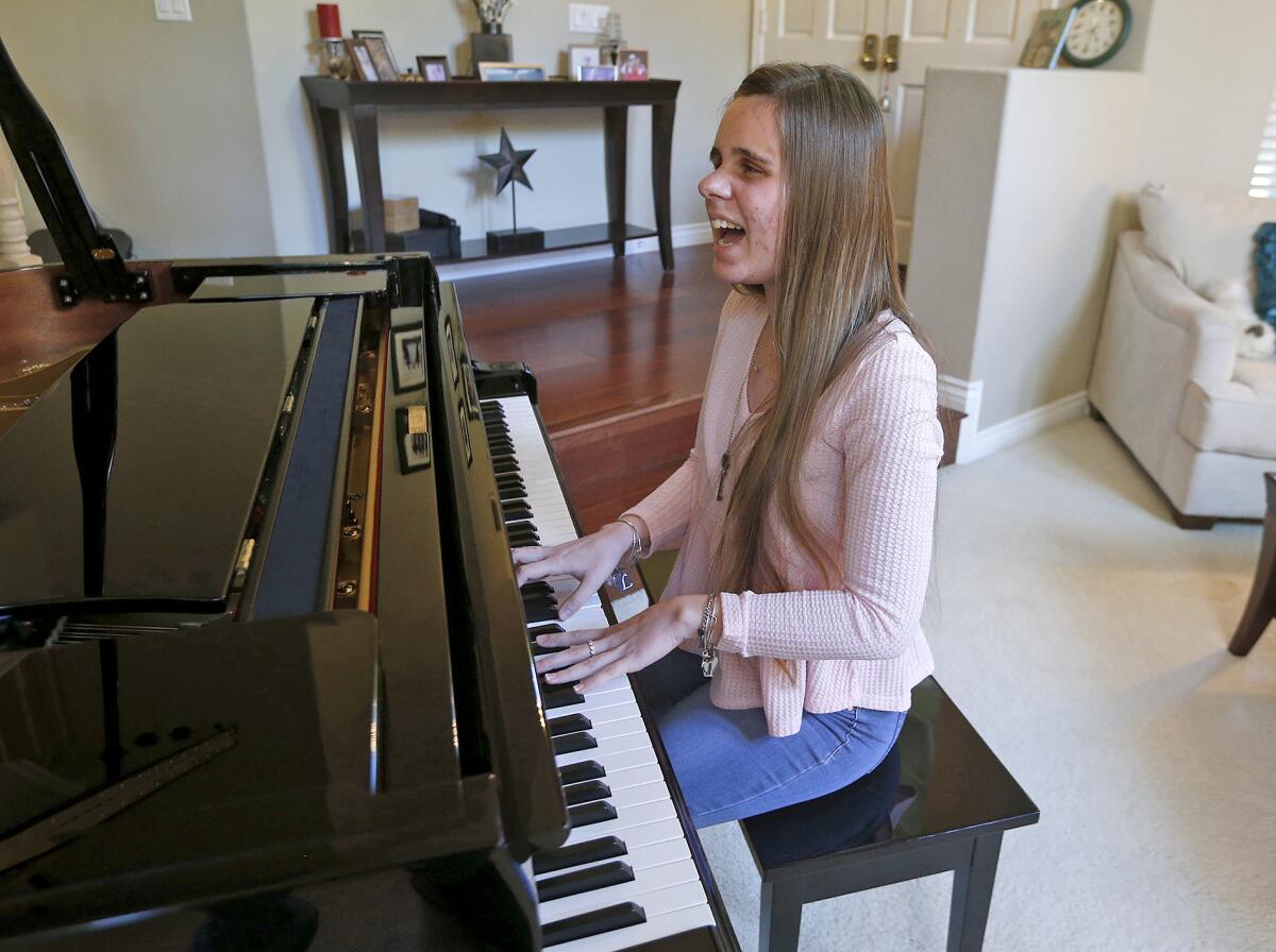 Lily Gabora plays an original song on her home piano.