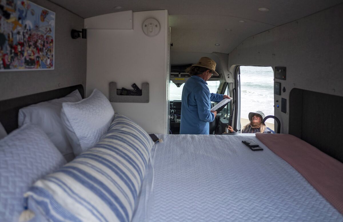 A large bed in the back of a van