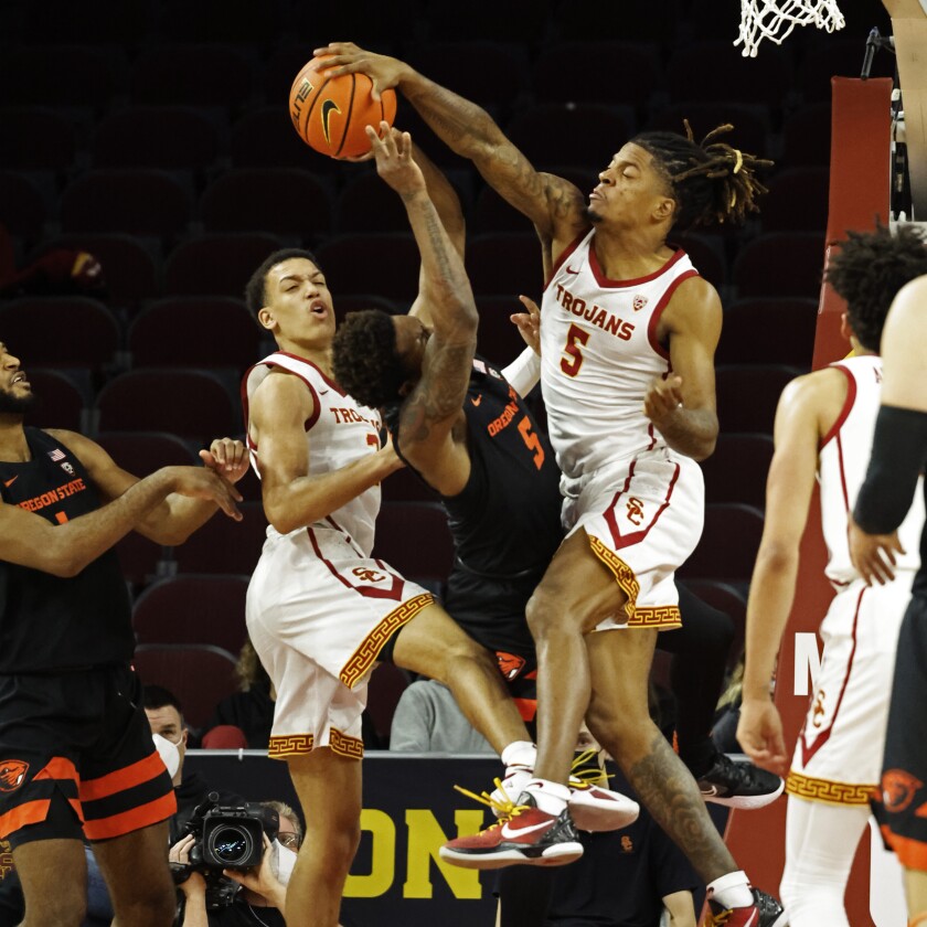 USC guard Isaiah White blocks a shot by Oregon State guard Xzavier Malone-Key.