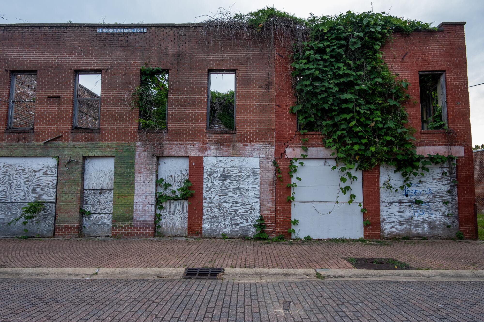 A roofless brick building stands abandoned.