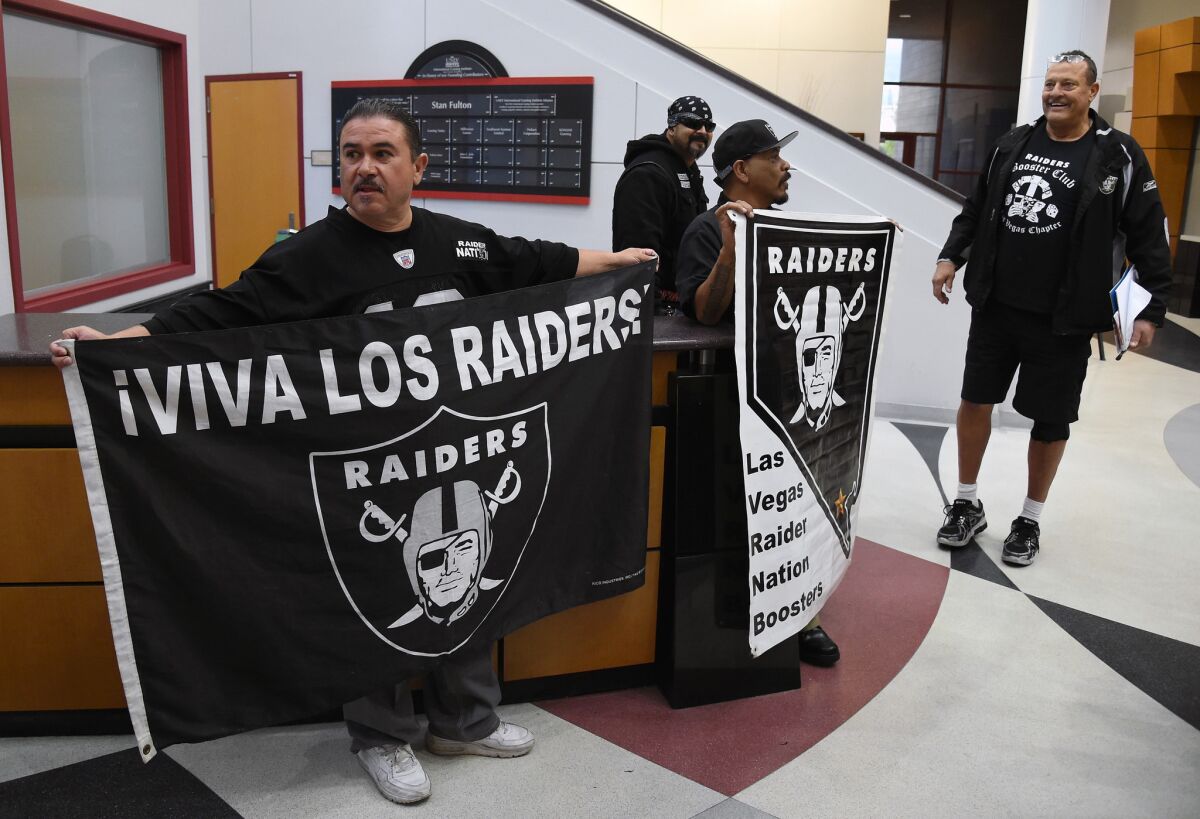 Raiders fans from Nevada wait for team owner Mark Davis to arrive at a Southern Nevada Tourism Infrastructure Committee meeting at UNLV on April 28.