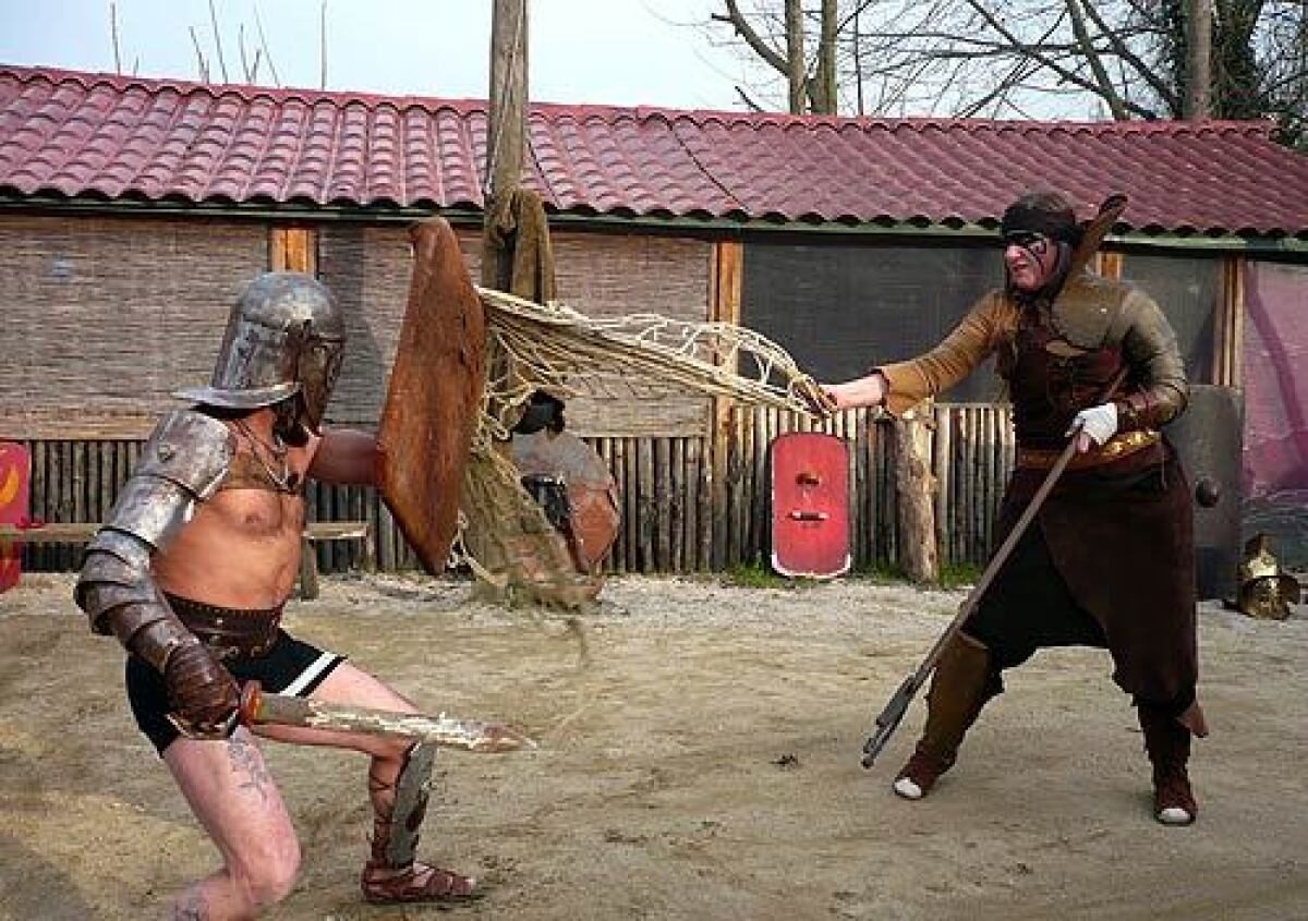 Gladiators Taurus (Michele D'Orazio) and Atropo (Giulia Mazzoli) fighting in the arena. They belong to a group of history buffs united by an obsession with ancient Rome, especially the gore and glory of the gladiator tradition.