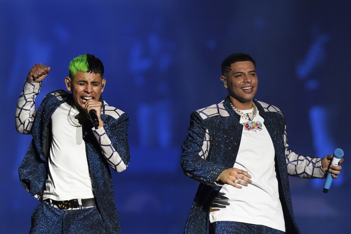 Vocalists Eduin Caz, right, and Jhonny Caz, left, of the Mexican regional band "Grupo Firme."