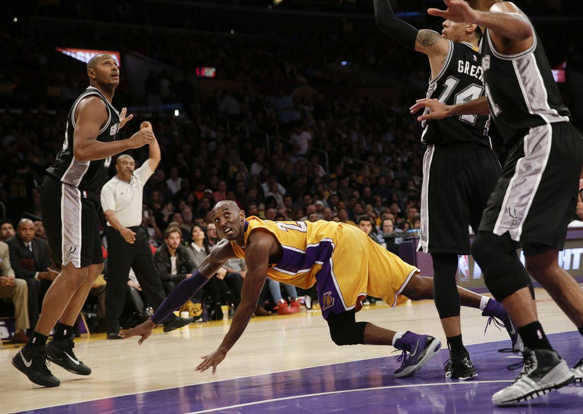 Kobe Bryant, center, watches his shot as he falls to the court against the San Antonio Spurs at Staples Center on Nov. 14.