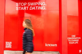 Known, an AI dating app, has their branding plastered on a store front in San Francisco's Marina District.