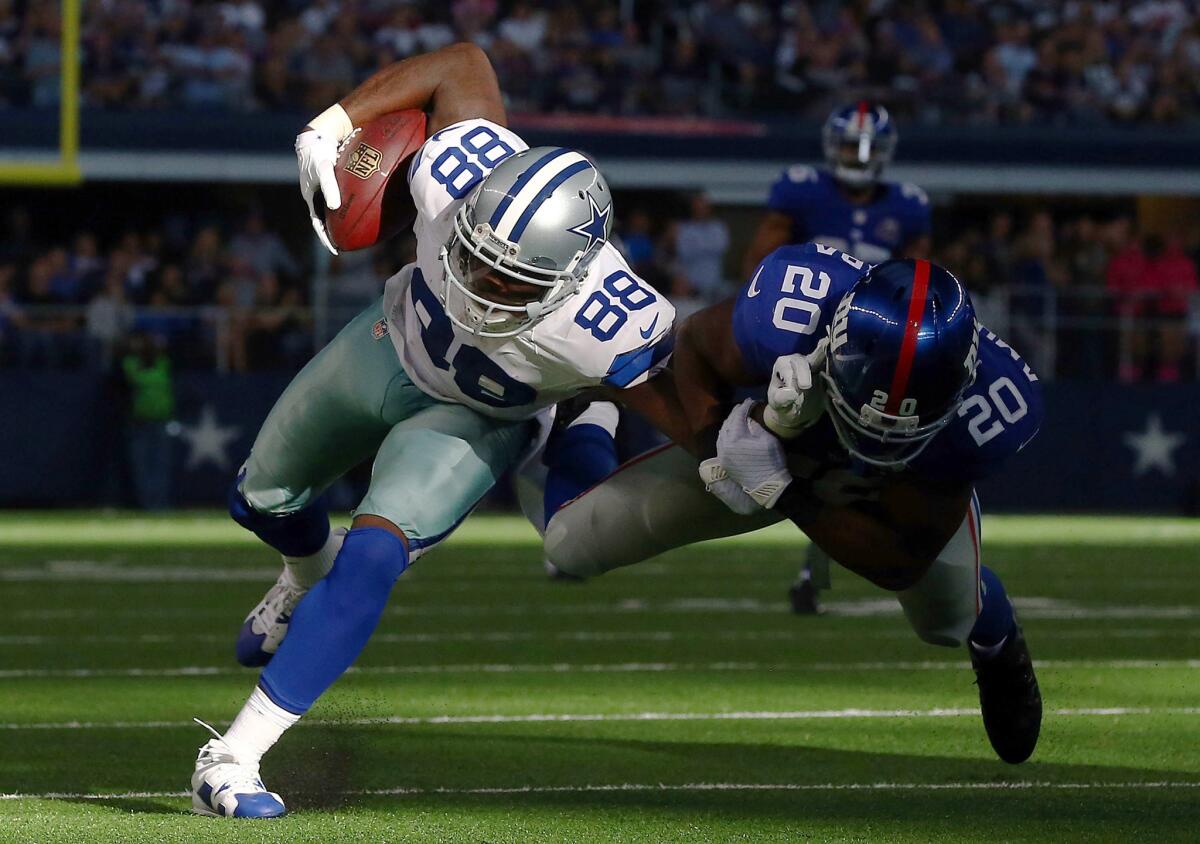 Dez Bryant (88) of the Dallas Cowboys runs after the catch as Prince Amukamara (20) of the New York Giants tries to make the tackle in the second half at AT&T Stadium on Sunday in Arlington, Texas.