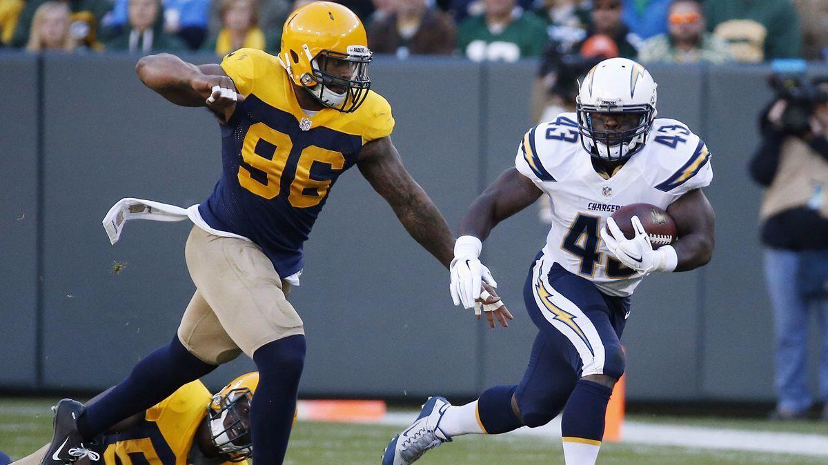 Chargers' Branden Oliver (43) is chased by Green Bay Packers' Mike Neal (96) during the first half on Oct. 18, 2015.