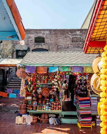 Vendor stalls filled with colorful goods at Olvera Street.