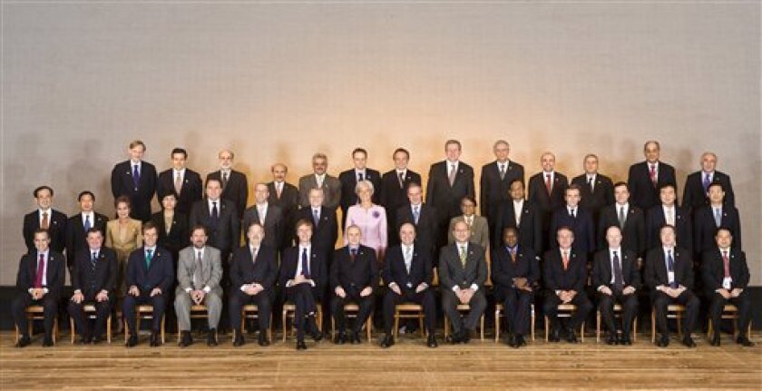In this photo released by Argosfoto, thhe Group of 20 nations finance ministers, central bank presidents, and World bank President Robert Zoellick, back row left, pose for a photo in Sao Paulo, Brazil, Saturday, Nov. 9, 2008. Brazil's President Luiz Inacio Lula da Silva on Saturday demanded that major reforms of the international financial system include strong input from large emerging nations and said the collapse of modern banking structures is victimizing the world's poor.(AP Photo/Marcos Issa-Argosfoto)