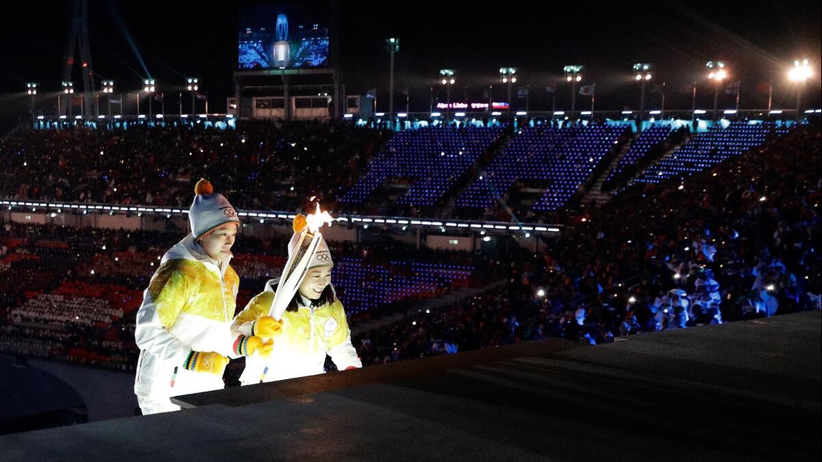 The torch is carried to the cauldron during the opening ceremony of the Winter Olympics in Pyeongchang, South Korea, on Feb. 9.