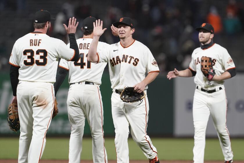 San Francisco Giants players celebrate after defeating the Miami Marlins in a baseball game in San Francisco, Thursday, April 22, 2021. (AP Photo/Jeff Chiu)