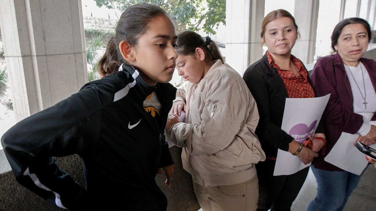 Fatima Avelica, left, with sister Yuleni, mother Norma and aunt Martina Avelica earlier this month at L.A. Superior Court to support her father, Romulo Avelica-Gonzalez, an immigrant who was detained by ICE agents as he drove her to school in Highland Park.