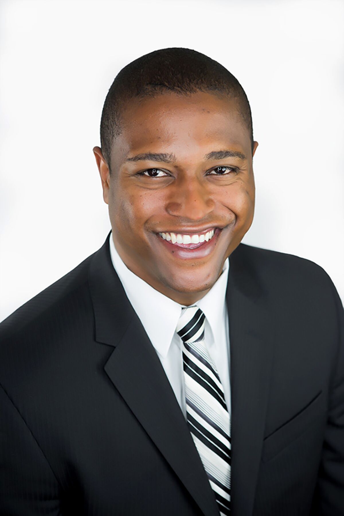 Headshot of a man in suit and tie