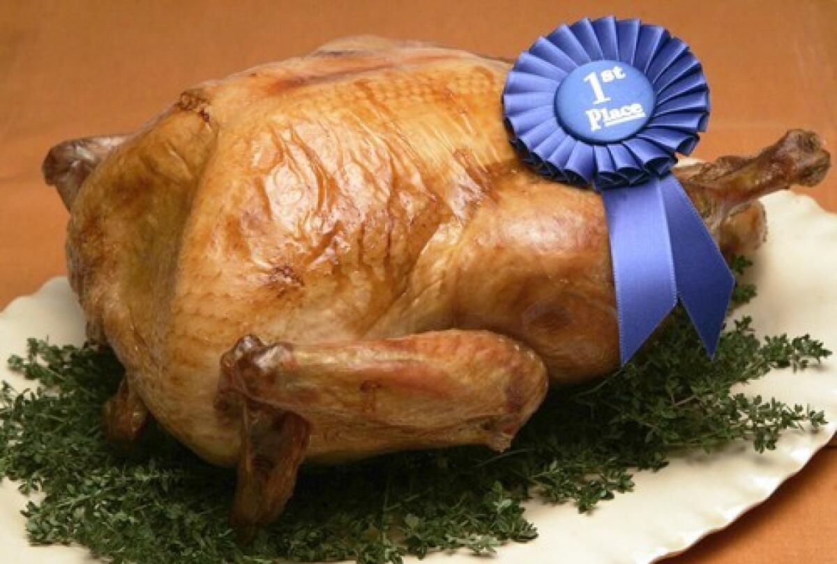 Cooked turkey on a platter with a first place award.