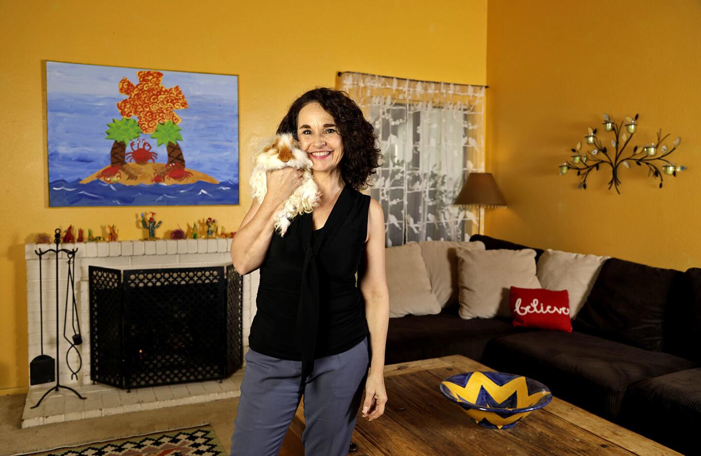 Actress Diane Franklin and her pet guinea pig in her sunny yellow living room.
