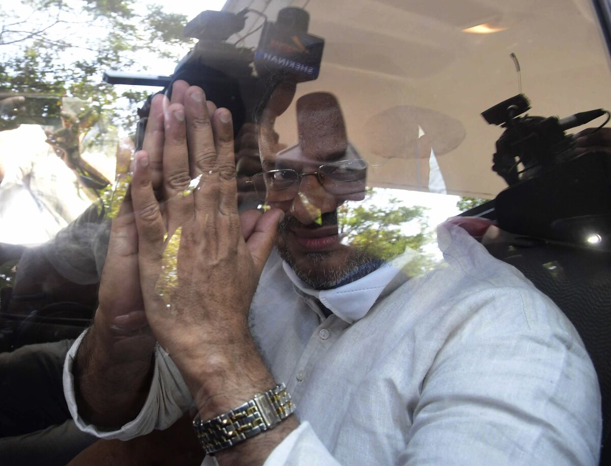 Bishop Franco Mulakkal greets the media as he leaves a court in Kottayam, India.