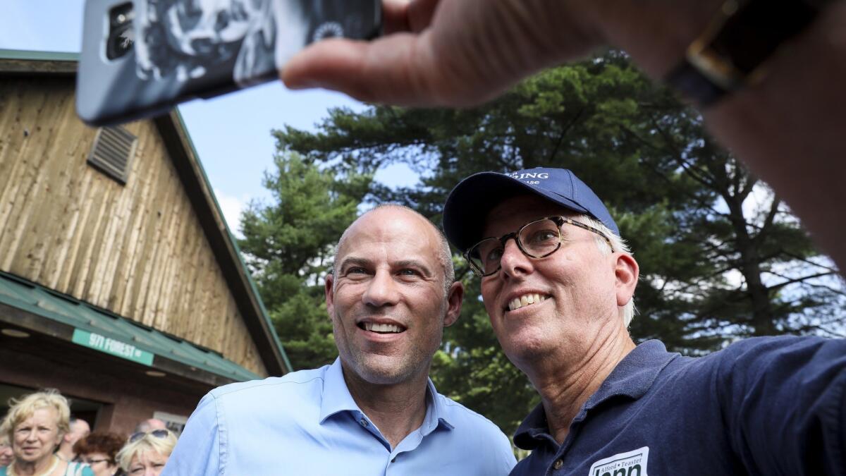 Michael Avenatti, left, poses for a selfie with Mike Munhall of Bennington after speaking at the Hillsborough County Democrats' Summer Picnic fundraiser in Greenfield, N.H., on Sunday.