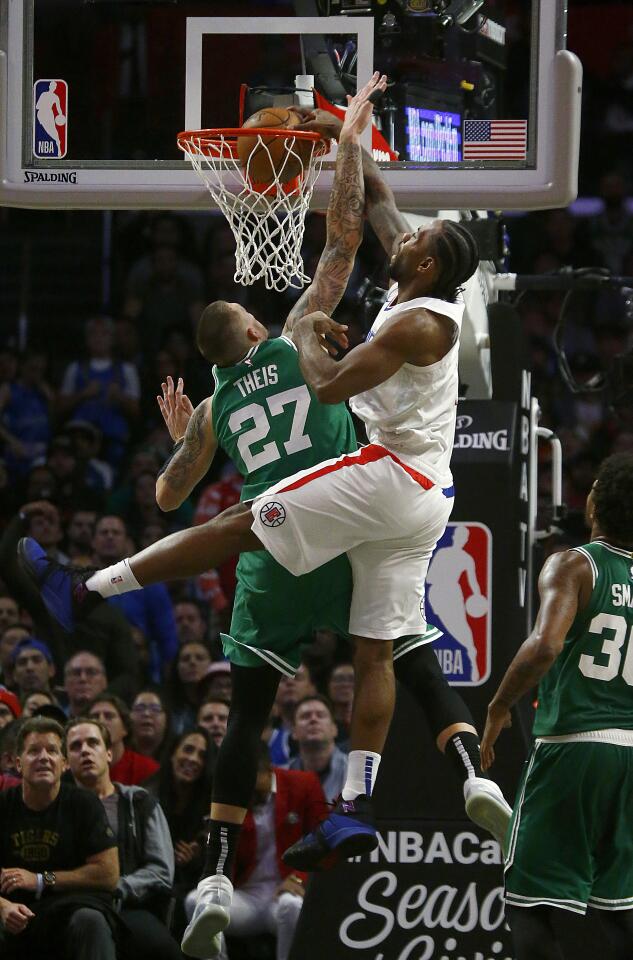 LOS ANGELES, CALIF. - NOV. 20, 2019. Clippers forward Kawehi Leonard throws down a dunk against Celtics forward Daniel Theis in thje fourth quarter at Staples Center in Los Angeles on Wednesday might, Nov. 20, 2019. (Luis Sinco/Los Angeles Times)